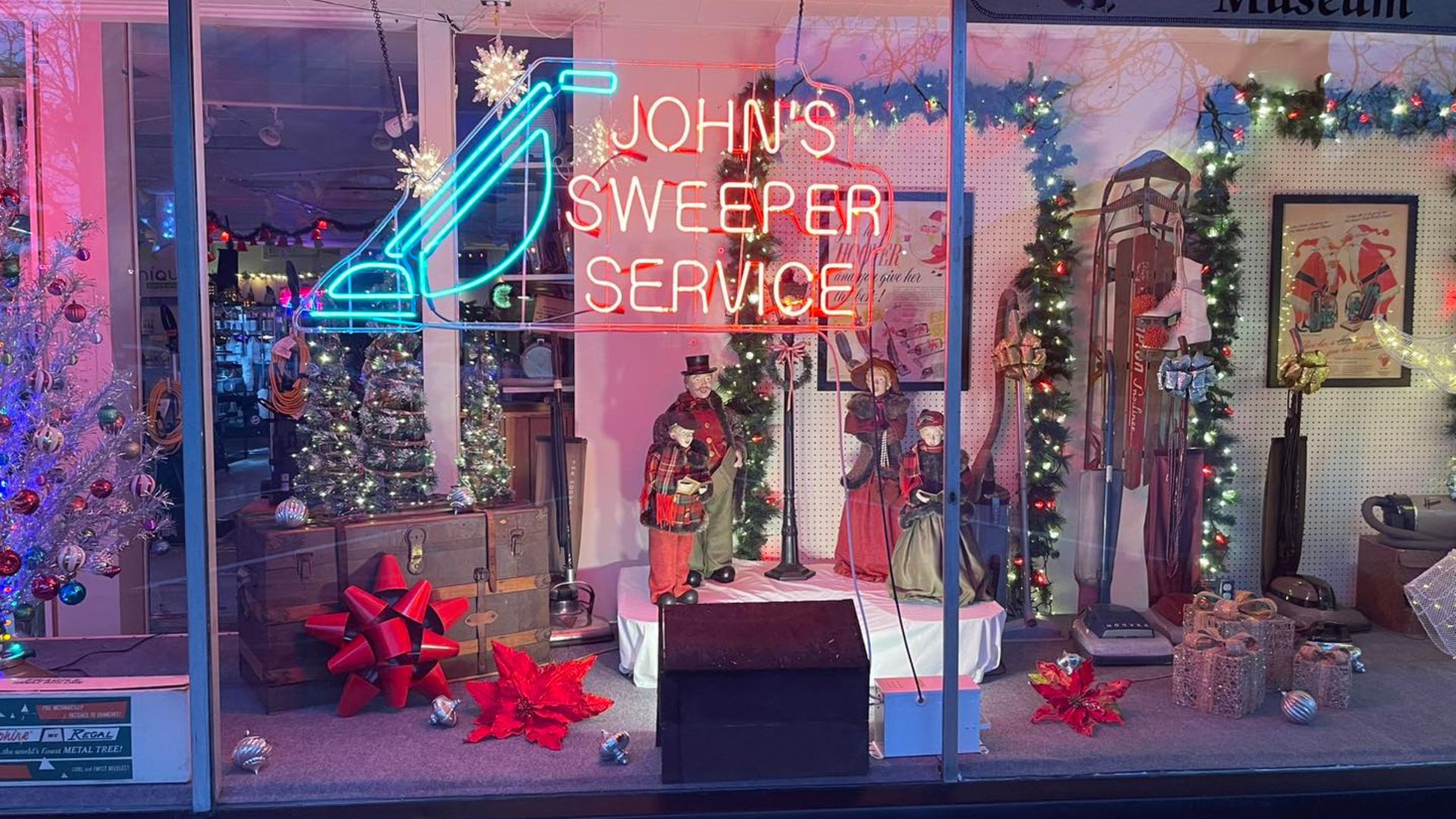 John's Sweeper storefront with a neon sign