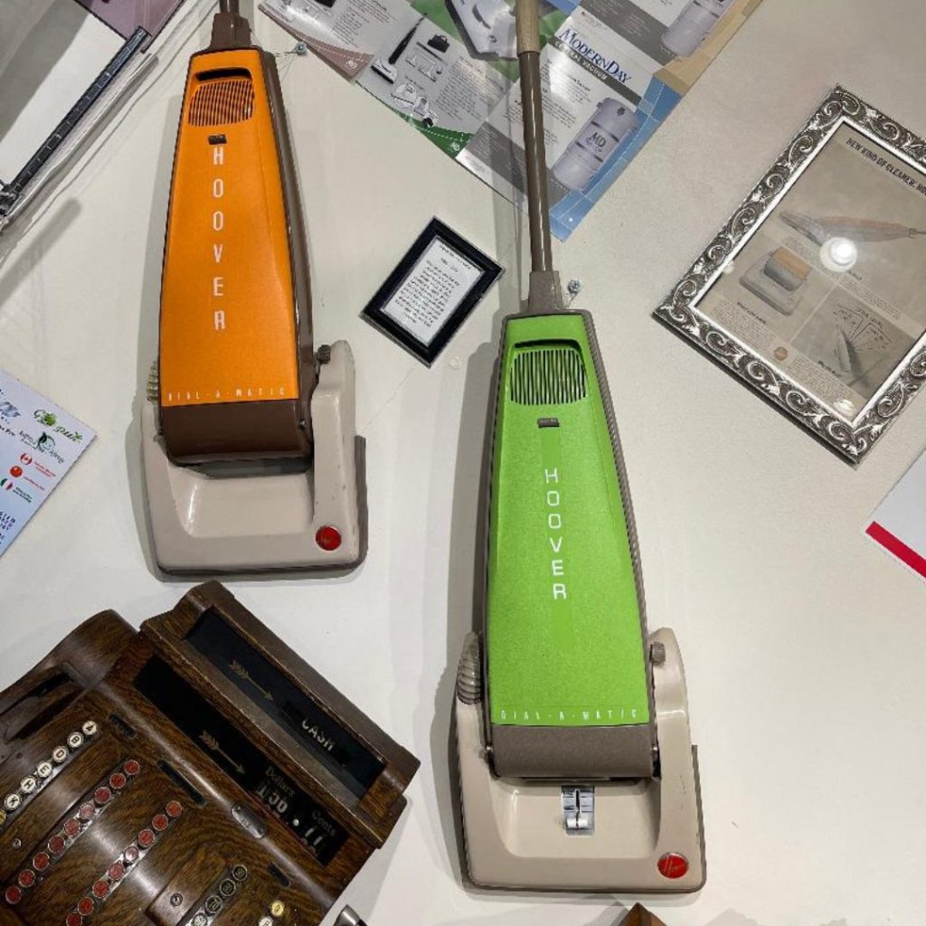 a group of Dial A Matic vintage vacuum cleaners on a table