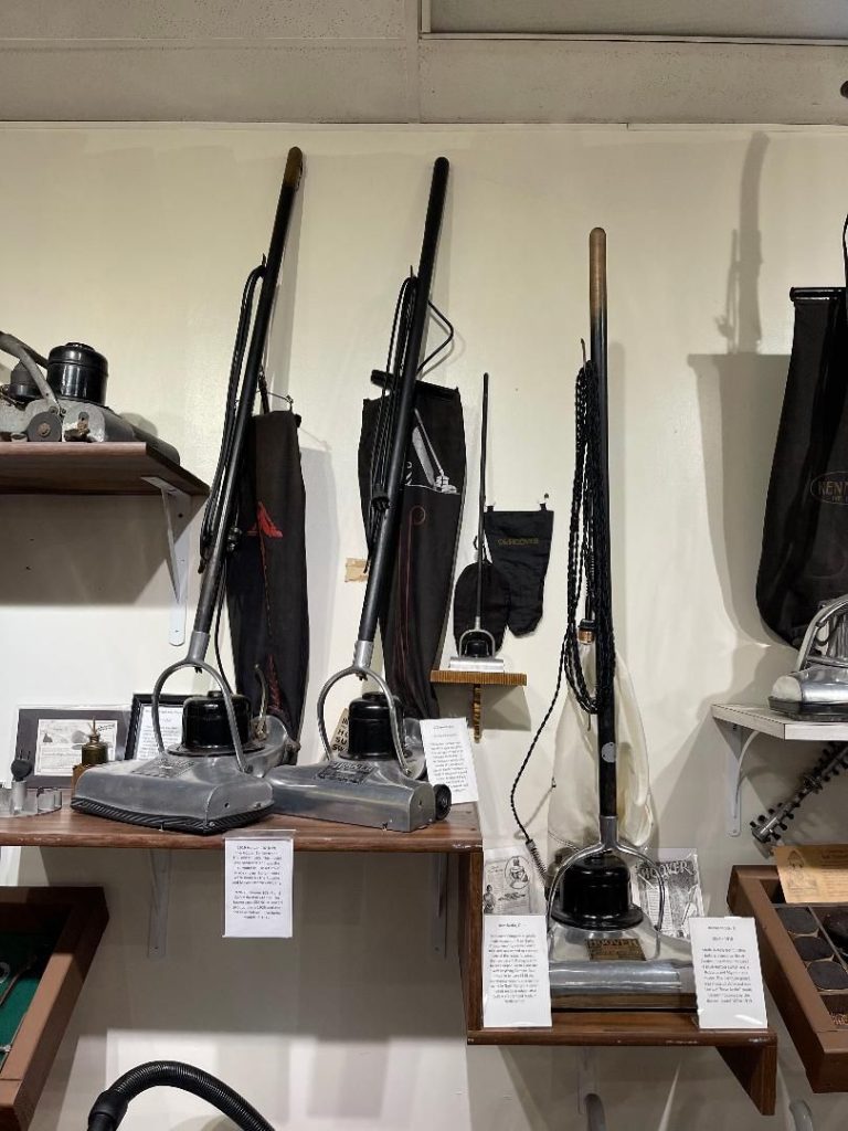 a group of Vintage Hoover Teens Vacuum on a shelf
