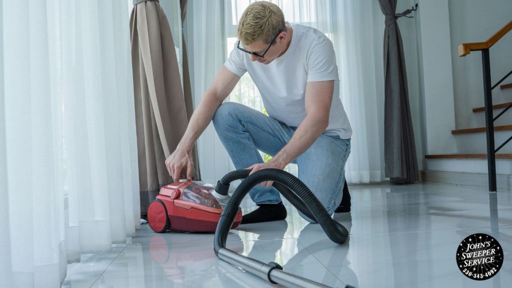 person on the floor with a broken vacuum